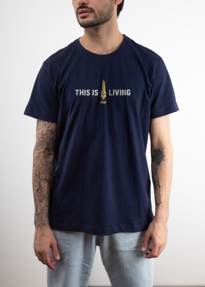 Camiseta Tradicional Azul "This is Living" Corona [PACK 50 UNIDADES]